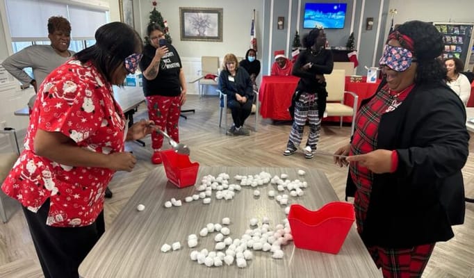 Staff engaging in a fun activity with residents