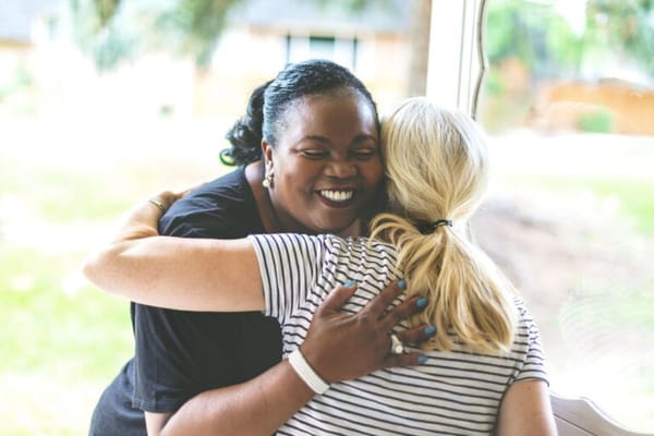Staff member hugging a resident indoors