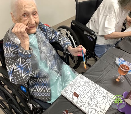 A resident painting during an activity in the facility