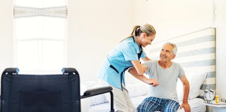 Staff assisting a resident in a bright room