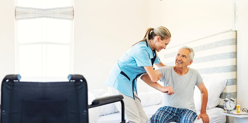 Staff assisting a resident in a bright room