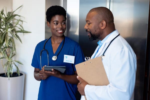 Healthcare professionals discussing in a facility hallway