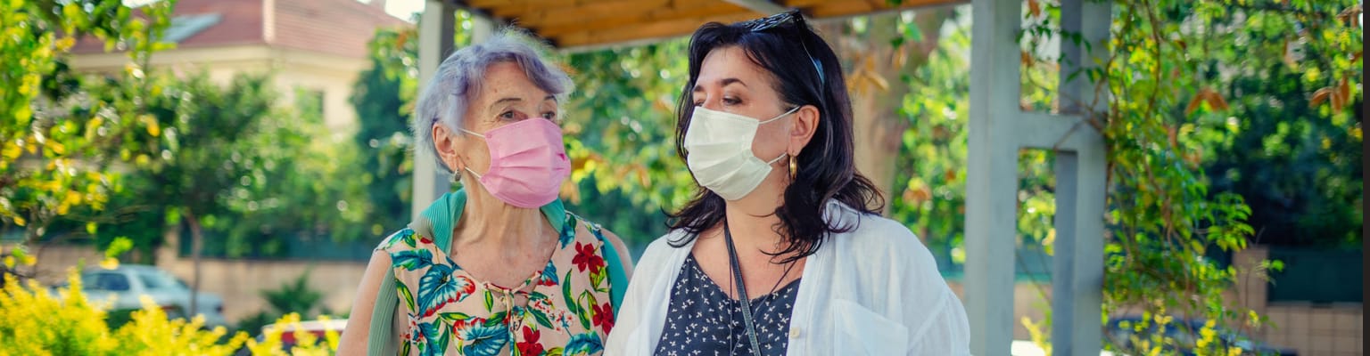Residents and staff interacting in a garden space
