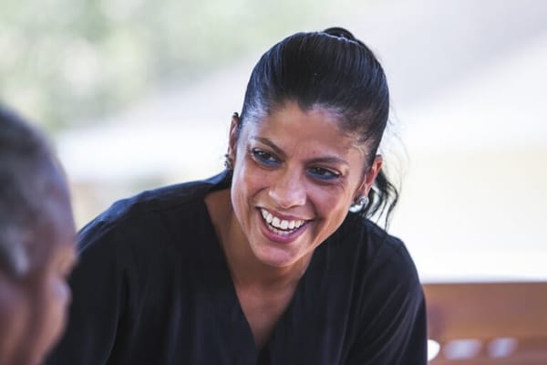A caregiver smiling while engaging with a resident