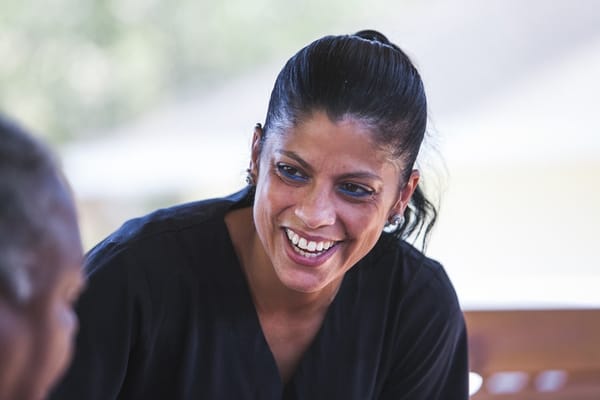 A caregiver smiling while engaging with a resident