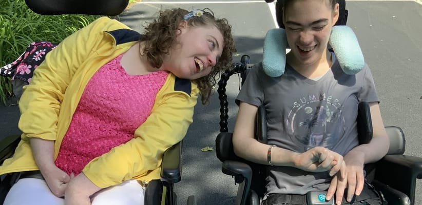Two residents enjoying a moment outdoors in wheelchairs