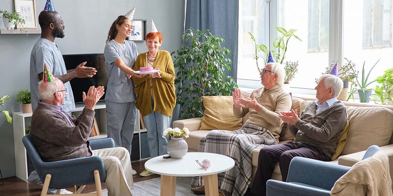 Residents celebrating a birthday in a common area
