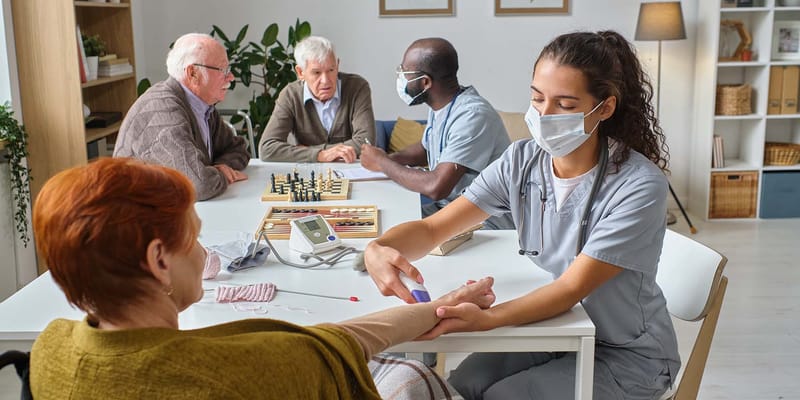 Nurse attending to a resident in a common area