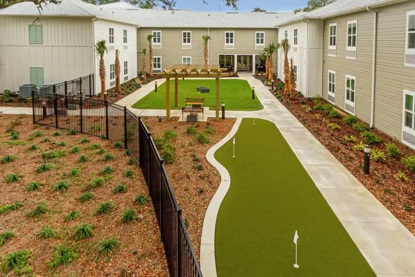 Outdoor courtyard with landscaping and putting green