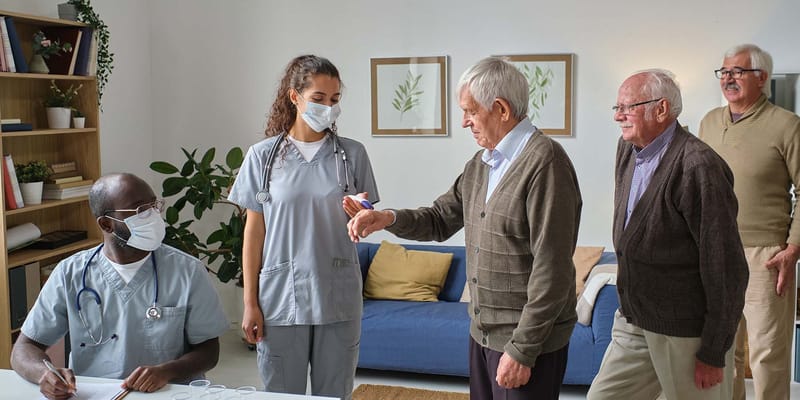 Residents interacting with staff in a common area