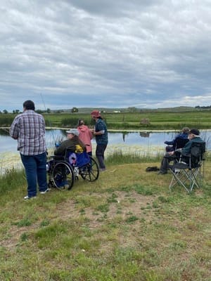 Residents fishing by a tranquil pond