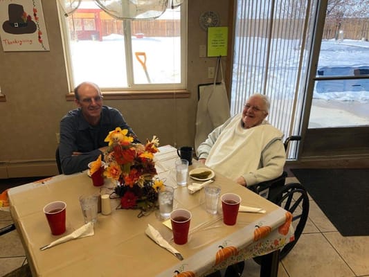 Residents enjoying a meal at a festive dining table