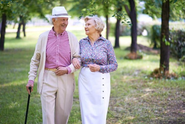 Elderly couple walking together in a park