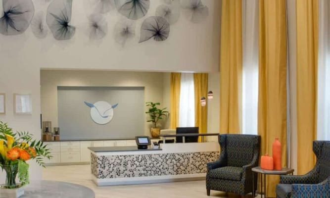 Bright reception area with comfortable seating and artwork