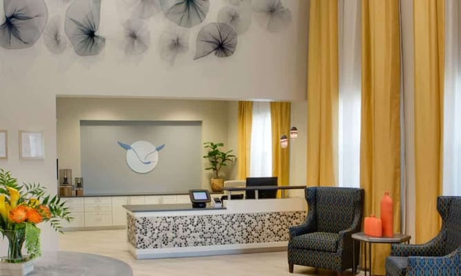 Bright reception area with comfortable seating and artwork