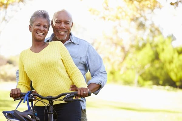 A smiling senior couple outdoors on a sunny day