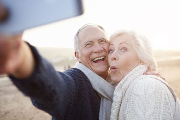 Happy senior couple taking a selfie outdoors