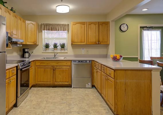 A well-lit kitchen area with wooden cabinets