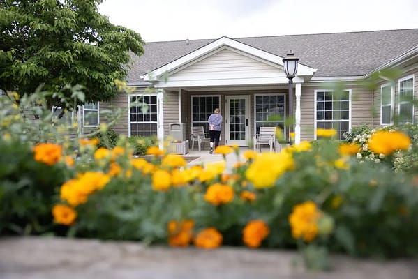 Entrance of a senior living facility with flowers