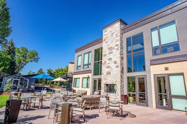 Exterior view of the assisted living facility with outdoor seating