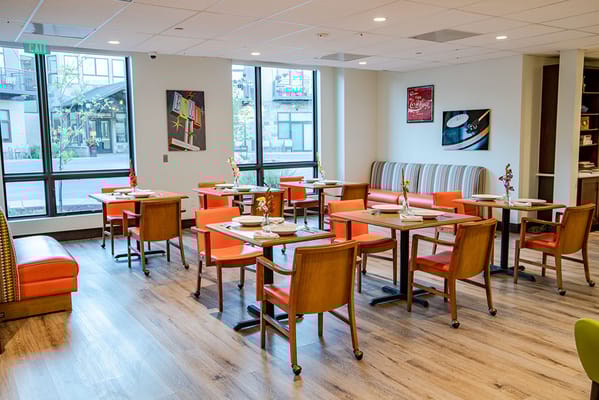 Bright dining area with colorful chairs and tables