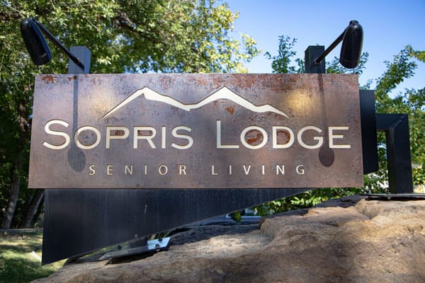 Facility logo sign with mountains in the background