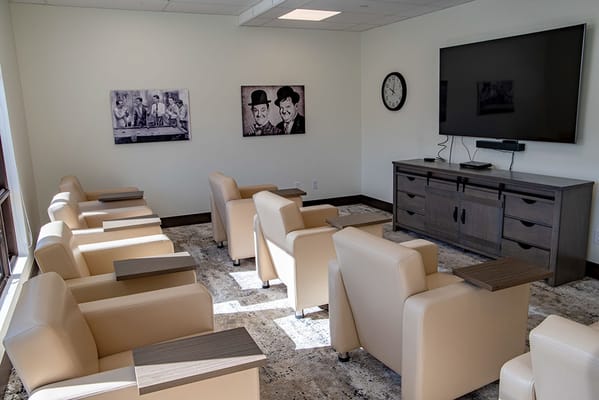 Cozy lounge area with chairs and artwork on the walls