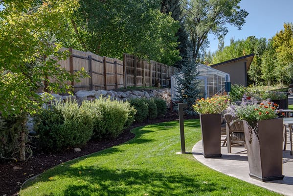 Well-maintained outdoor garden area with seating