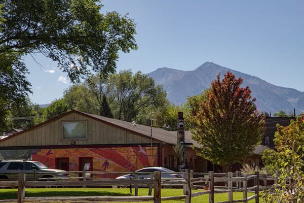 Exterior view of a facility with mountains in the background