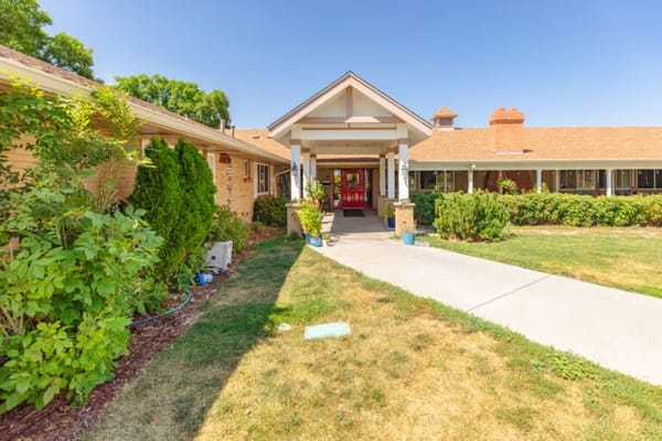 Entrance of Arvada Care and Rehabilitation Center with landscaped pathway