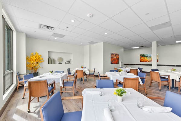Bright and clean dining room with tables set for meals