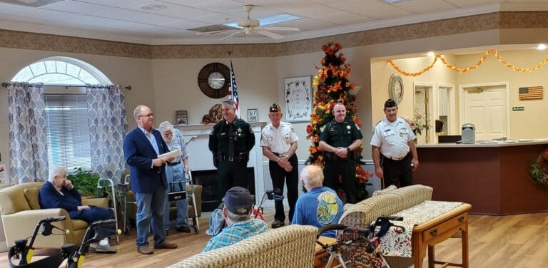 A gathering in the common area with staff and residents