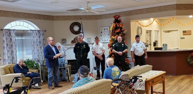 A gathering in the common area with staff and residents