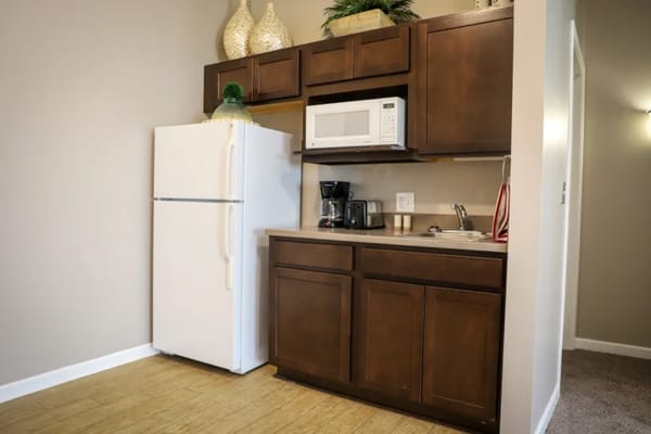 Interior kitchenette area with refrigerator and microwave