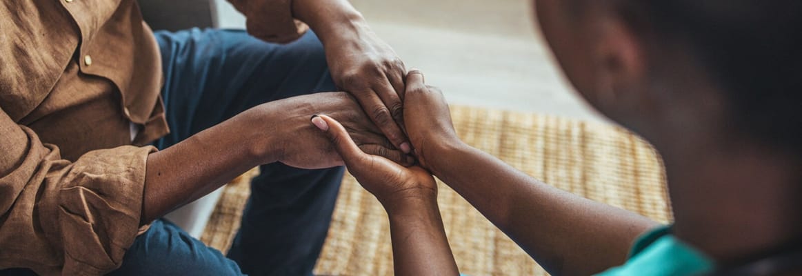Close-up of hands engaged in support activity