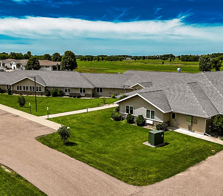 Aerial view of a senior living community with lawns
