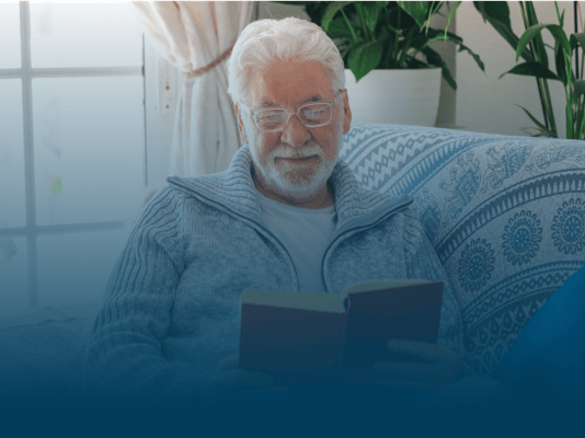 Resident reading a book in a cozy setting