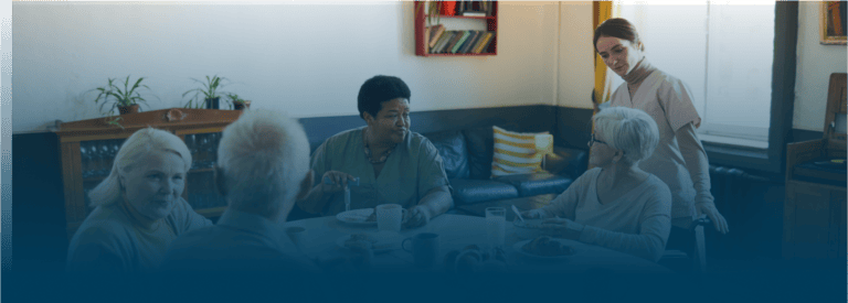 Residents enjoying a meal in a cozy common area