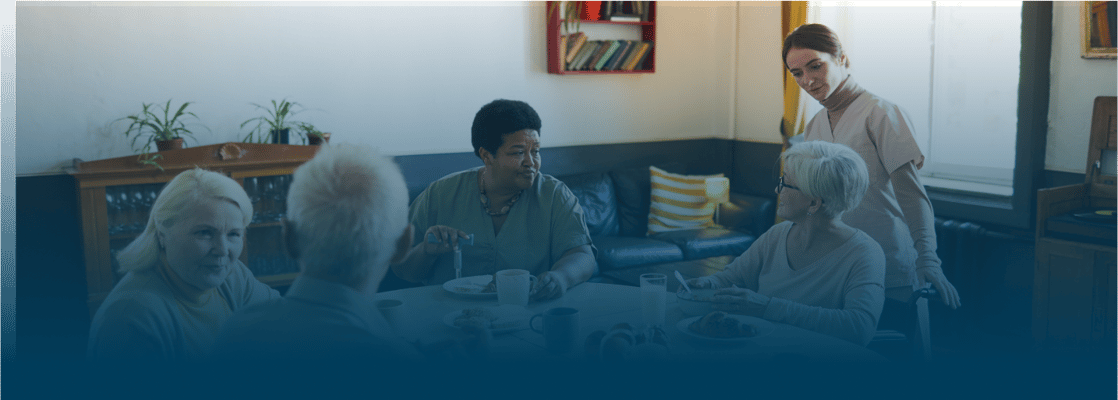 Residents enjoying a meal in a cozy common area