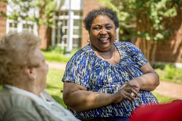 Residents sitting outside enjoying a conversation
