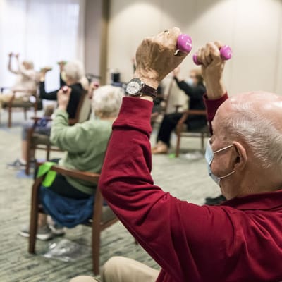 Residents participating in a seated exercise class