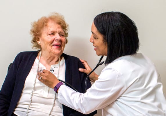 Healthcare worker interacting with a senior resident