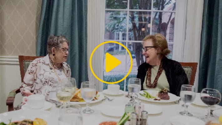 Two residents enjoying a meal together in the dining room