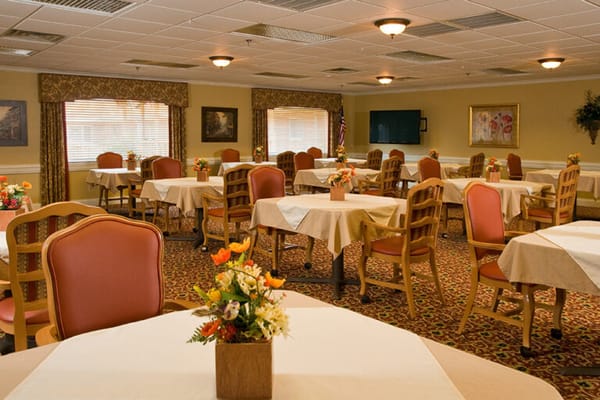 Bright dining room with tables set for meals