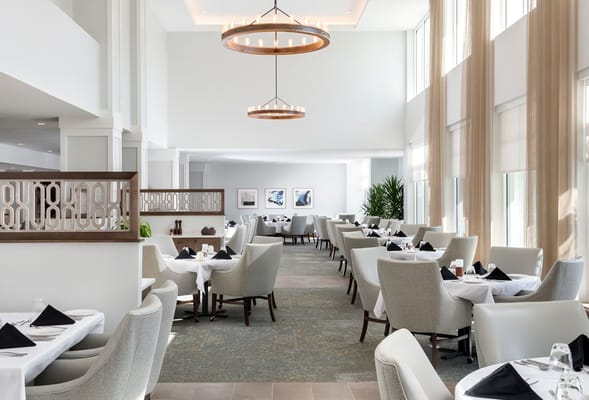 Bright dining room with tables set for meals