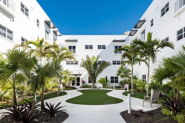 Outdoor courtyard with green landscaping and seating