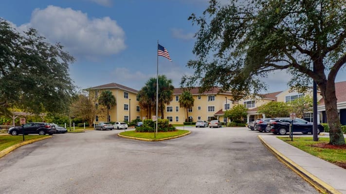 Exterior view of Aventura Bay Place with landscaped entrance
