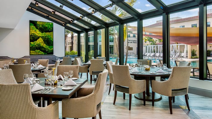 Modern dining area with elegant seating and large windows