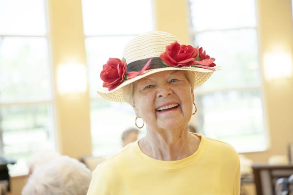 A smiling resident wearing a decorated hat