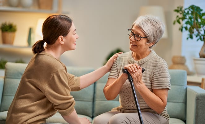 Staff member engaging with a resident in a cozy lounge